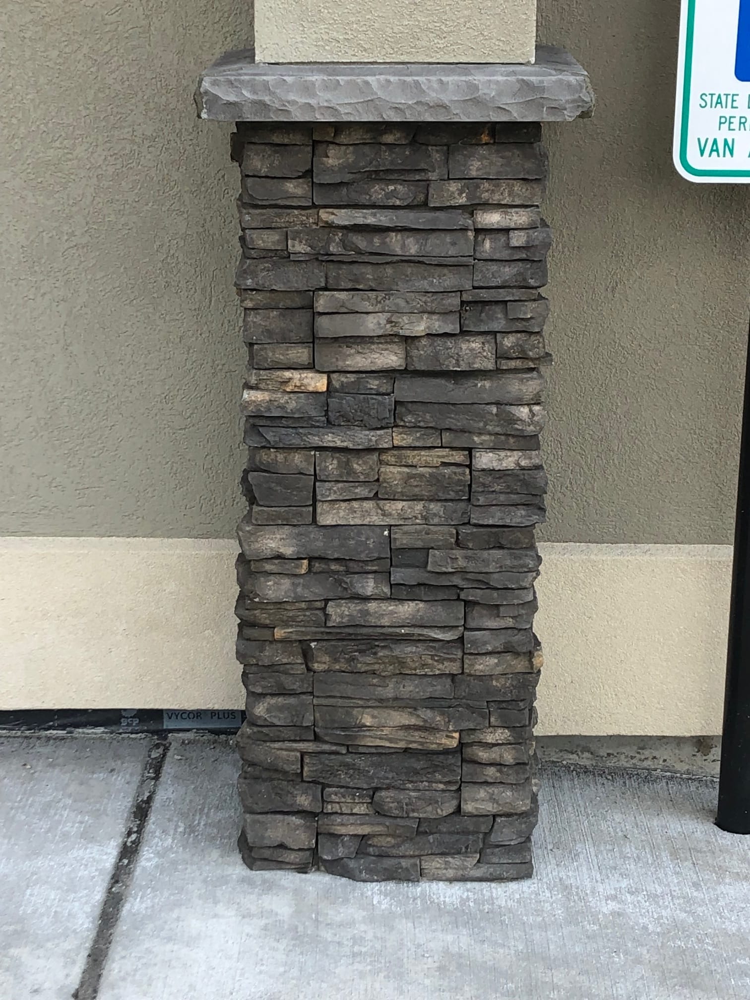 Porch column finished with a stacked-stone veneer base