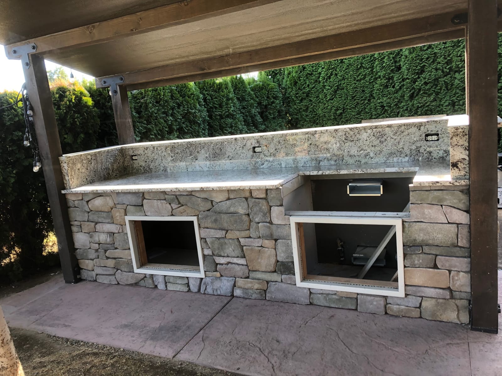 Outdoor kitchen island with openings framed for appliances