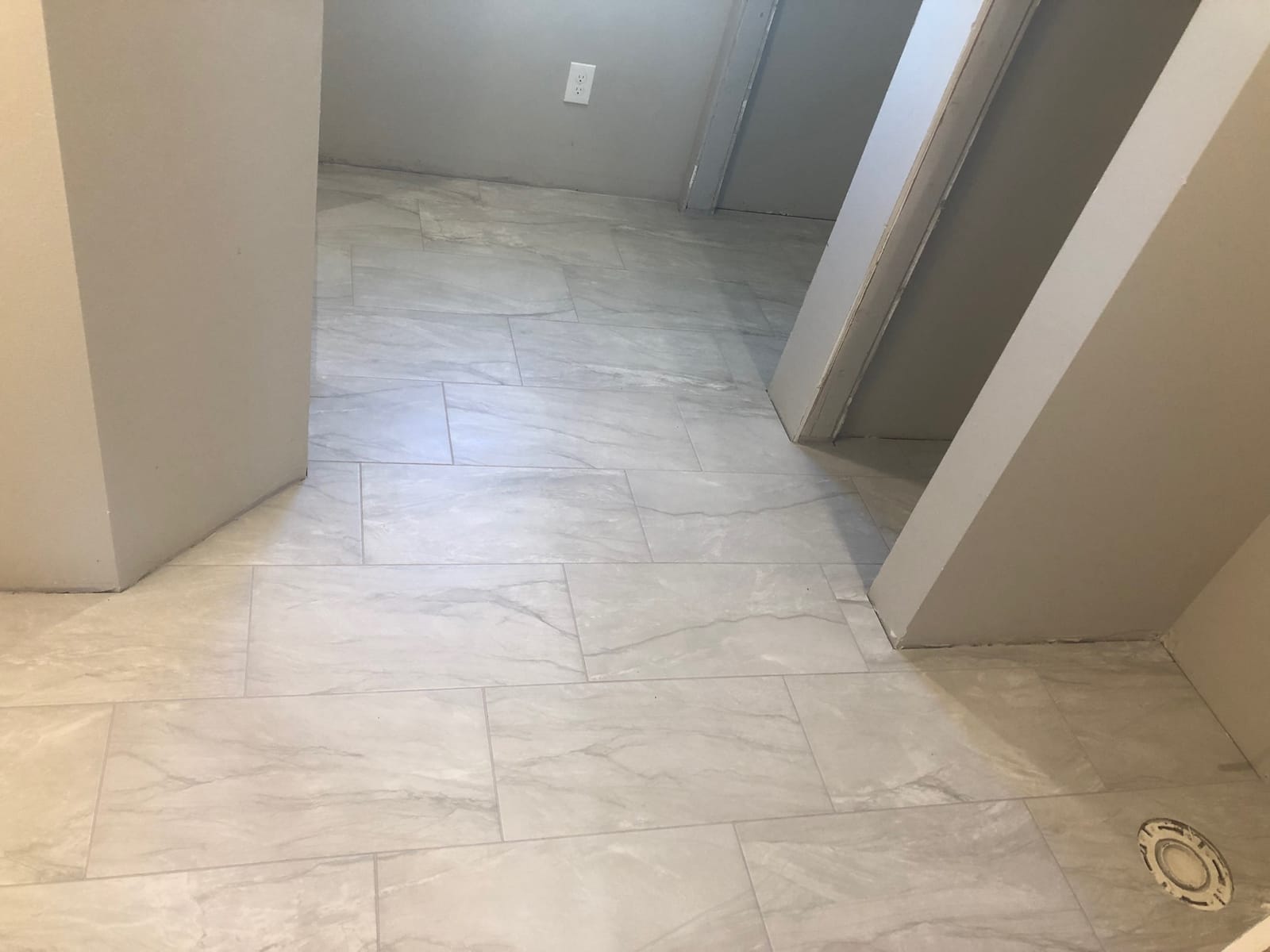 New marble-look tile floor during a bathroom remodel