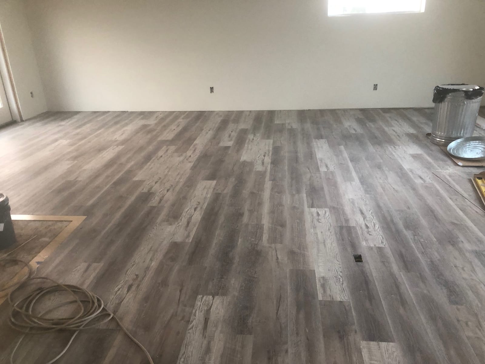 Wide-plank flooring installed across an open room