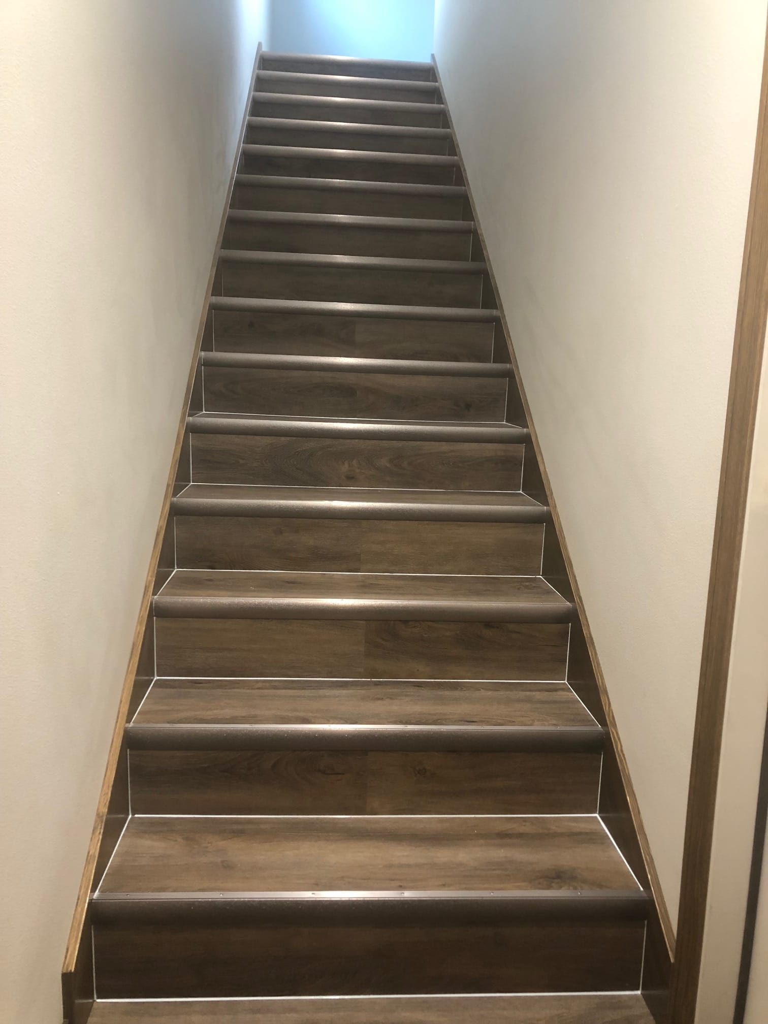 Remodeled staircase with wood-look treads and non-slip nosing