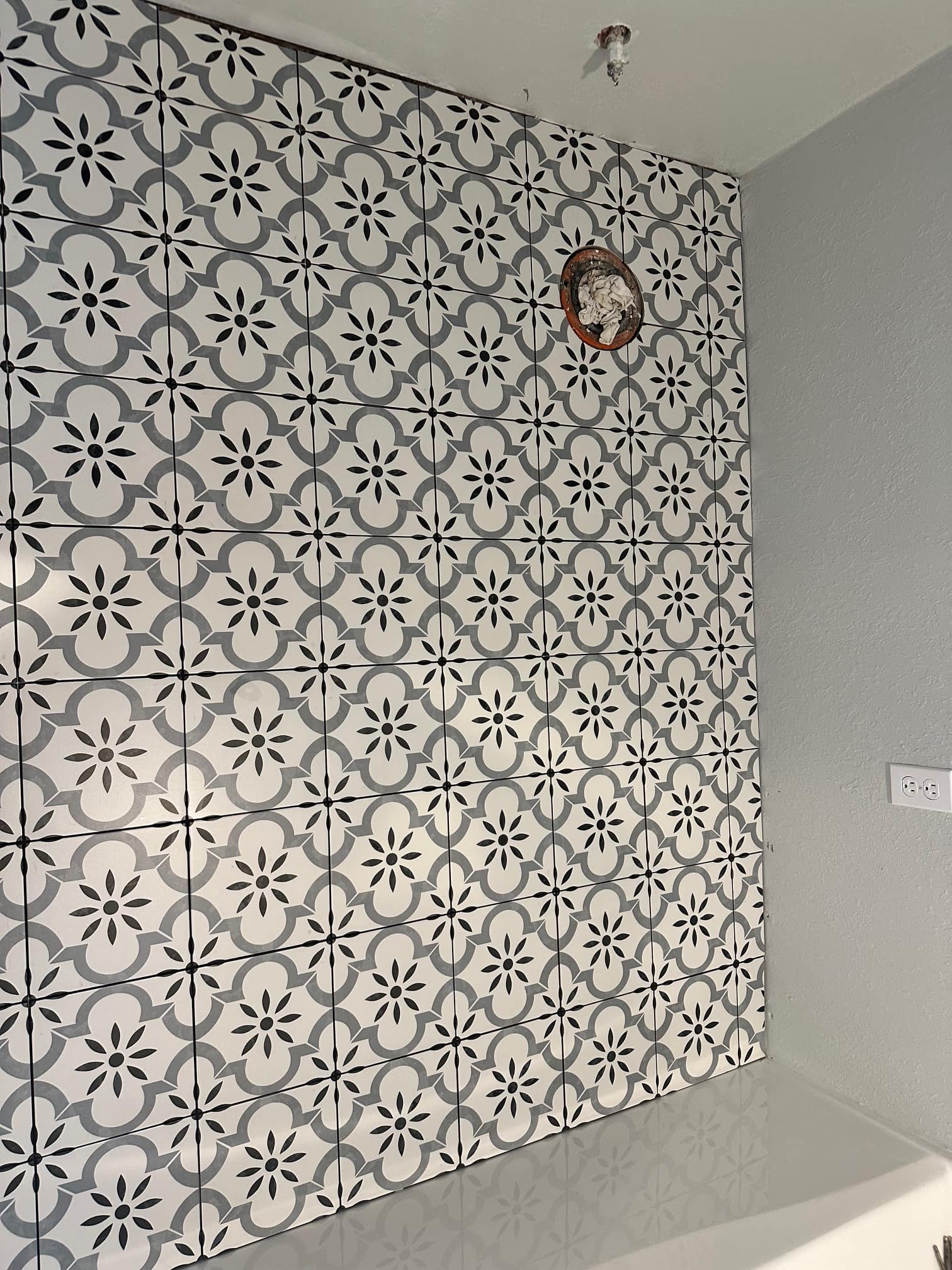 Patterned tile accent wall in a remodeled bathroom
