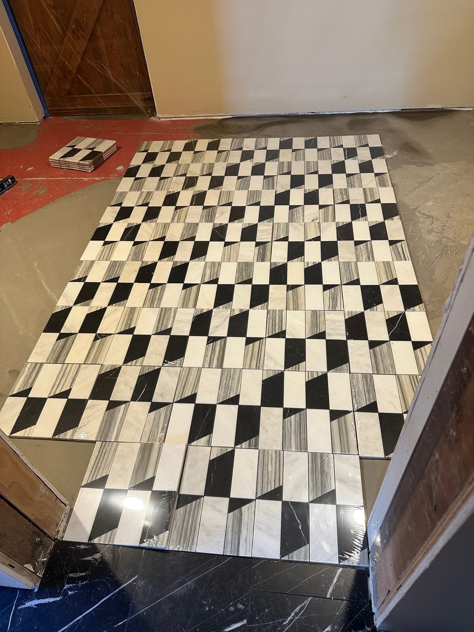 Geometric marble tile dry-laid before installation in a wine cellar