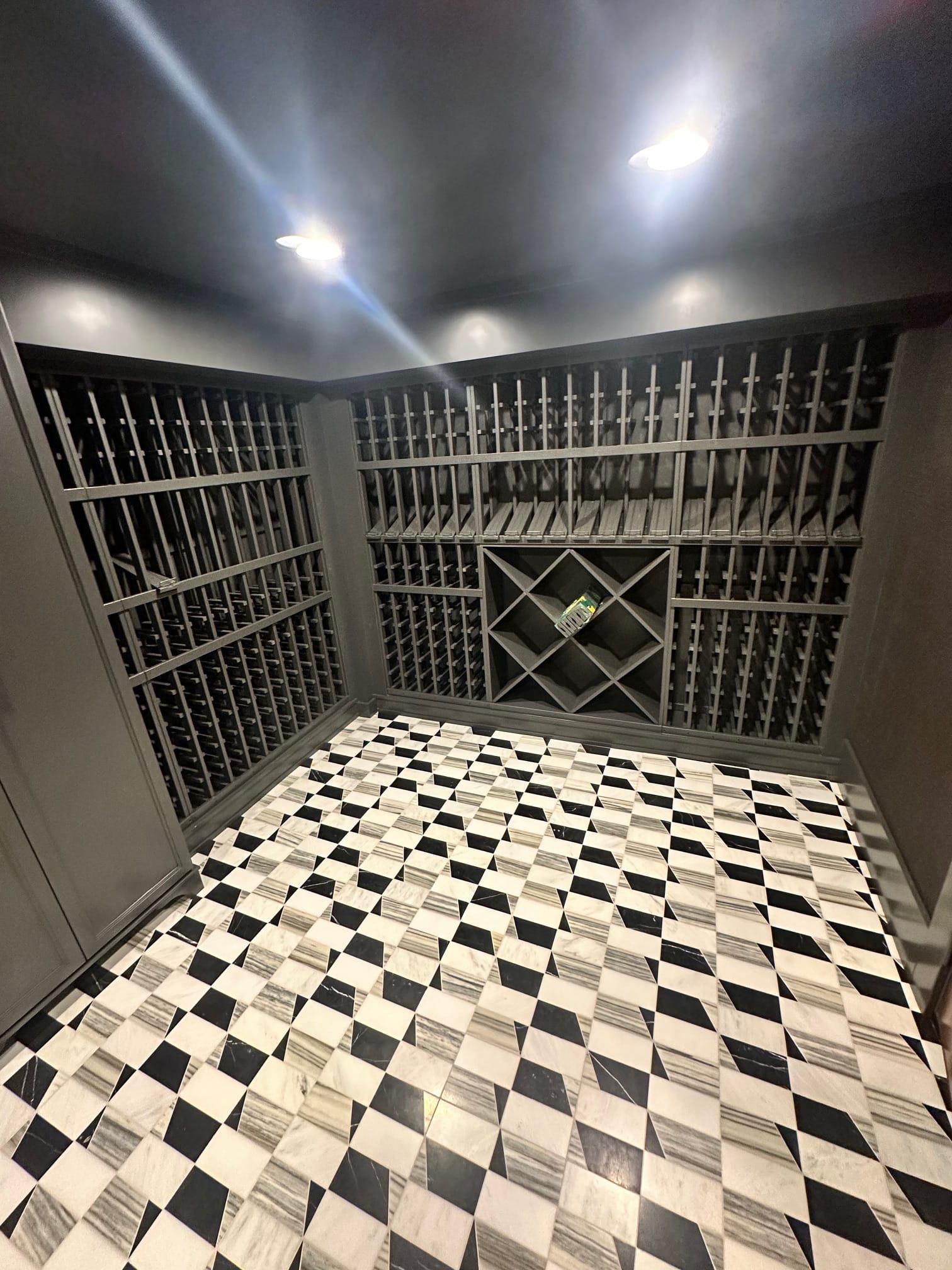 Finished wine cellar with custom racking and geometric marble floor