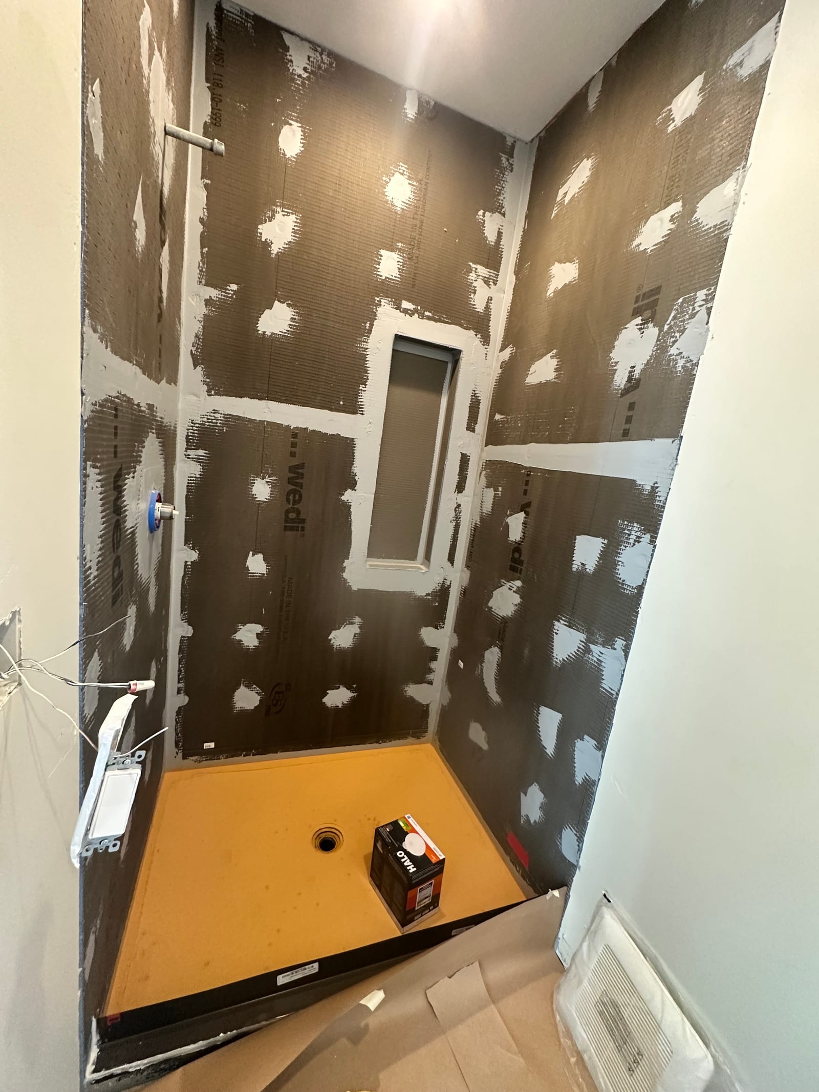 Same shower lined with waterproof panels before tile